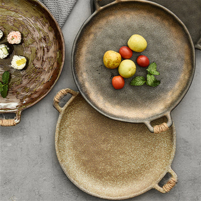 Two-handled hammered ceramic serving plate from above showing glaze variation
