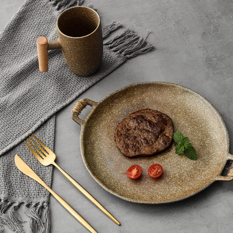 Hammered-glaze ceramic serving plate with two small handles and a reactive earthy glaze