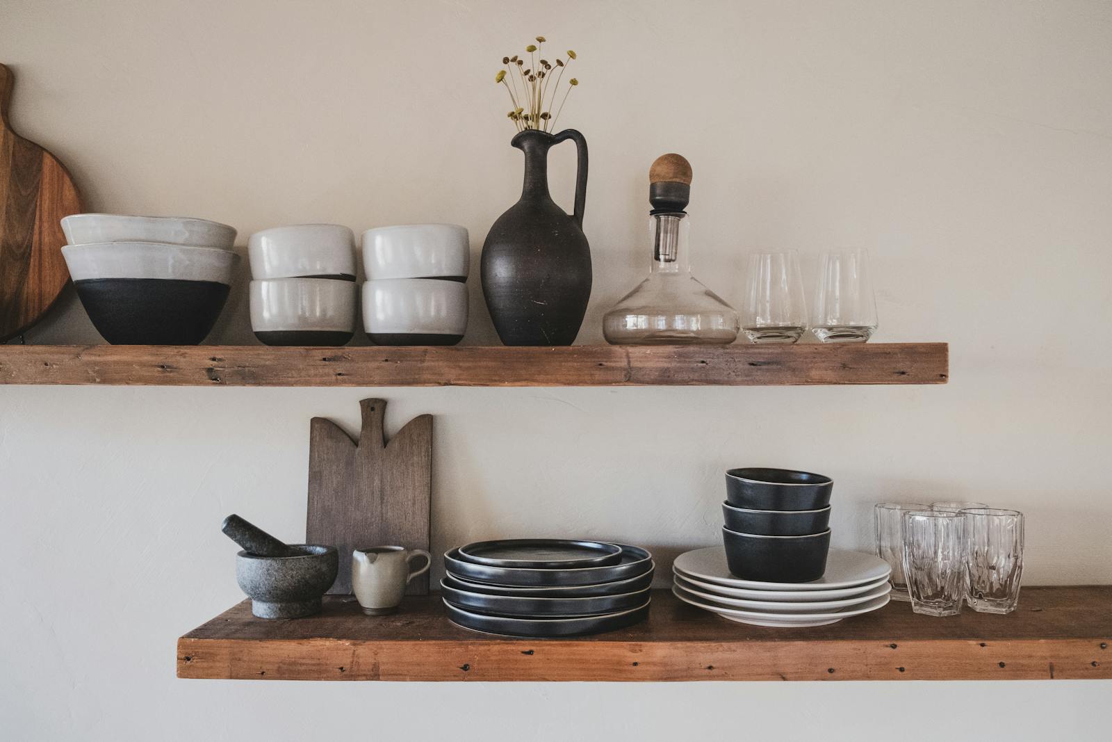 Hand-finished ceramic bowls on a wooden shelf